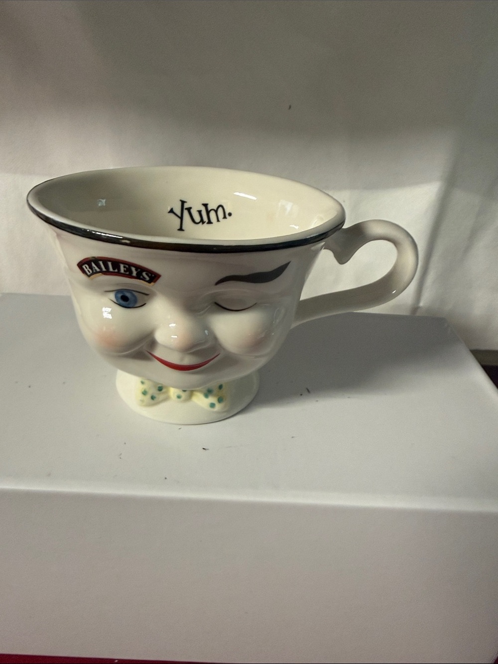 Bailey Cream Ceramic
Winking Face Teacup -